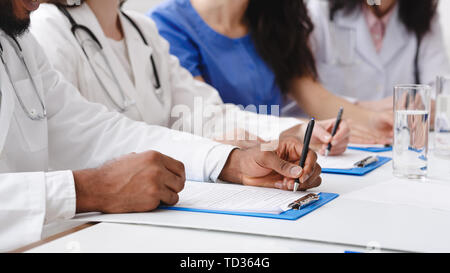 Medical Education. Doctors Writing Notes At Conference Stock Photo