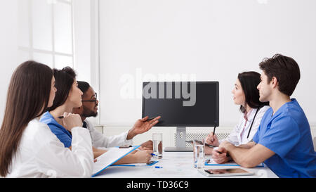 Remote Medicine. Team of Doctors Parsing Difficult Case From Patient Stock Photo