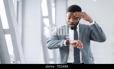 Businessman Missed Plane, Looking At Watch At Airport Stock Photo