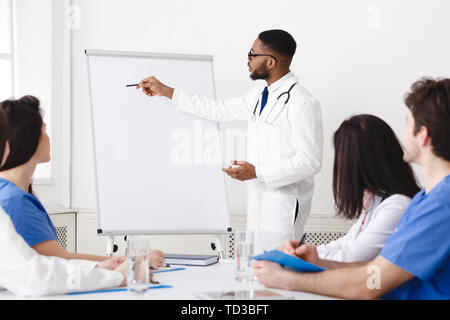 Weekly Meeting. Team Of Doctors Having Brainstorming Session Stock Photo