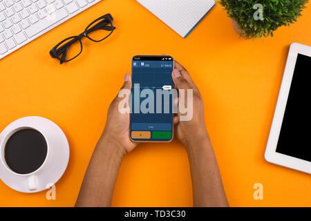 Investor analyzing stock market investments on smartphone Stock Photo