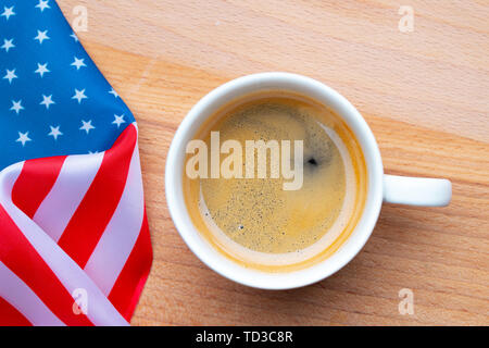 Independence Day USA concept. Memorial Day. Cup of coffee with American flag on white background top view flat lay Stock Photo