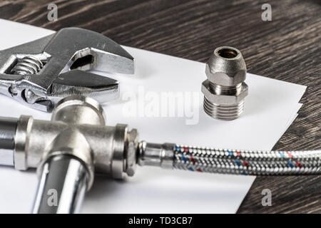 Plumbing pipeline element and adjustable wrench Stock Photo