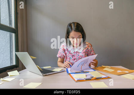 Office woman checking financial report documents in the office Stock Photo