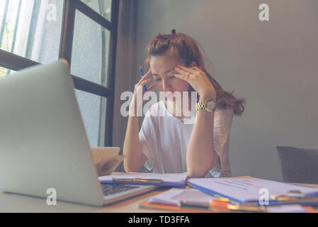Young beautiful lady focus on reading documents while working Stock Photo