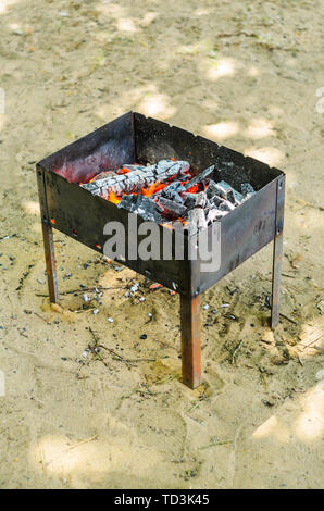 Fire woods and hot coals in bbq pit. Stock Photo