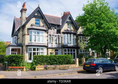 Classic period Victorian detached luxury family house with garden and car parked in front Stock Photo