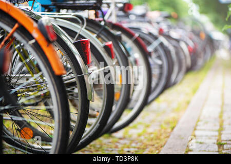 Group of bicycles in the row on parking for bikes in big European city. Stock Photo