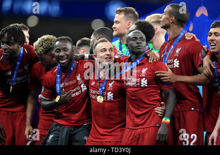 Left to right, Liverpool's Divock Origi, Alex Oxlade-Chamberlain, Naby Keita, Xherdan Shaqiri, Sadio Mane, Joel Matip and Roberto Firmino celebrate after the UEFA Champions League Final at the Wanda Metropolitano, Madrid. Stock Photo