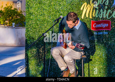 MONTEVIDEO, URUGUAY, JUNE - 2019 - Man playing guitar at outdoor street fair at carrasco neighborhood, montevideo city, uruguay Stock Photo