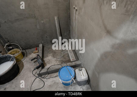 The basis of shower cabin. Bathroom during finishing work. Laying tiles on the wall and floor. Home renovation, demolishing in bathroom. Stock Photo