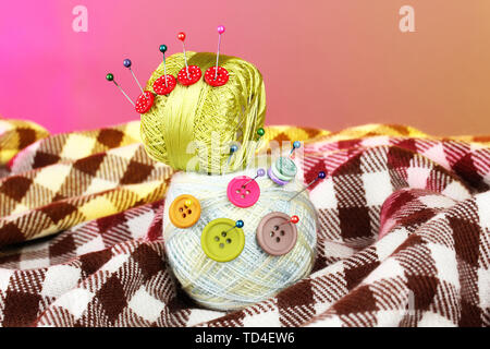 Buttons of different colors, and the two tangle thread on a colorful background Stock Photo