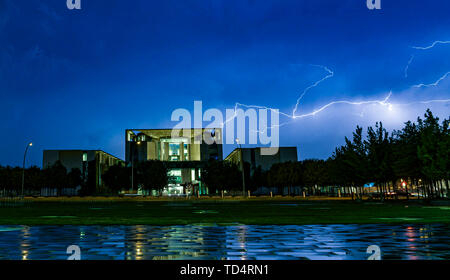 Berlin, Germany. 11th June, 2019. Lightning flashes across the sky during a thunderstorm at the Federal Chancellery. Credit: Paul Zinken/dpa/Alamy Live News Stock Photo