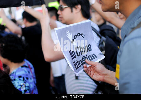 New York City, United States. 09th June, 2019. A demonstrator holds a placard that says no china extradition during the protest. Hundreds of demonstrators rally in New York City to protest Chinese Extradition laws affecting Hong Kong. Demonstrators gathered in Times Square then marched to the Chinese Embassy on the city's west side. Credit: SOPA Images Limited/Alamy Live News Stock Photo