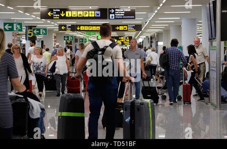 Palma, Spain. 10th June, 2019. Tourists pass through the arrival terminal at Mallorca Airport. After a long series of record years, the tourists suddenly stay away. The concern is so great that one even looks at the weather forecast for Germany. (to dpa-Korr 'Alarm on Mallorca: Tourist calm threatens the holiday island') Credit: Clara Margais/dpa/Alamy Live News Stock Photo