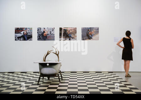 Krakow, Poland. 11th June, 2019. A woman looks at a photograph part of the group exhibition Nature in Art at the Museum of Comtemporary Art. Nature in Art shows contemporary works of more than 70 artists from several countries, in techniques ranging from painting, photography and video to object and installation. The exhibition has been divided into five parts: Beauty, Ecology, Confrontation, Matter and Symbol. Credit: SOPA Images Limited/Alamy Live News Stock Photo