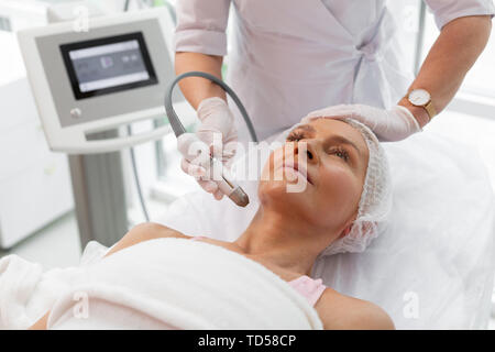 Neck contour. Nice good looking woman having a lifting procedure while correcting the neck contour Stock Photo