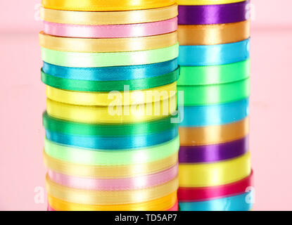 Bright ribbons on pink background Stock Photo