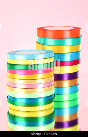 Bright ribbons on pink background Stock Photo