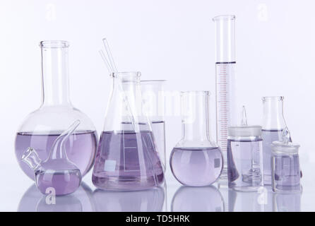 Test-tubes with light purple liquid isolated on white Stock Photo