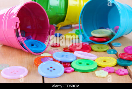 Colorful buttons strewn from buckets close-up Stock Photo