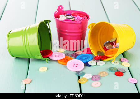 Colorful buttons strewn from buckets close-up Stock Photo