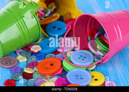 Colorful buttons strewn from buckets close-up Stock Photo