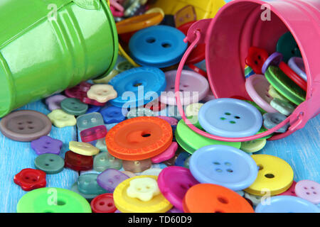 Colorful buttons strewn from buckets close-up Stock Photo