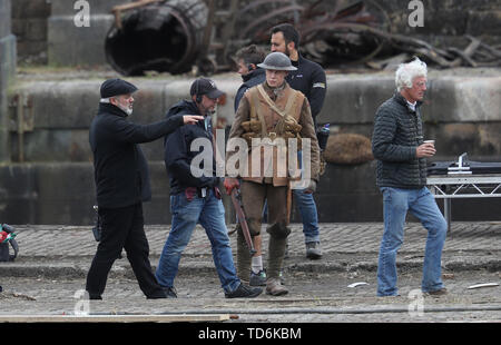 Director Sam Mendes (left) on the set of his new film 1917 with cinematographer Roger Deakins (right) and George MacKay (centre) at Govan Docks in Glasgow. Stock Photo