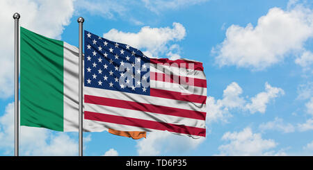 Ireland and United States flag waving in the wind against white cloudy blue sky together. Diplomacy concept, international relations. Stock Photo