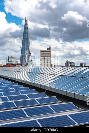 London cityscape with the Shard in the distance. Shot from the member's room at Tate Modern - seen in the foreground with the solar panels. Stock Photo