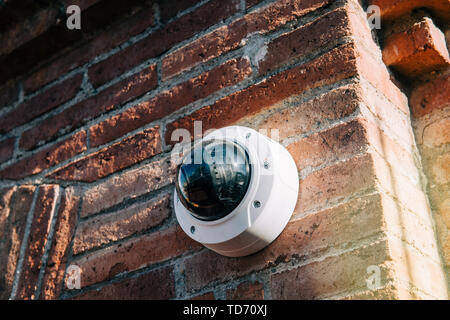Barcelona, Spain - Nov 14, 2017: Axis 360 degrees surveillance camera on brick wall. Axis Communications AB is a Swedish manufacturer of network camer Stock Photo