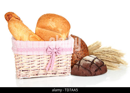Baked bread in wicker basket isolated on white Stock Photo