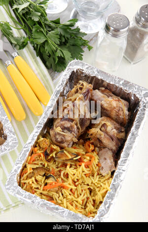 Food in boxes of foil on tablecloth Stock Photo