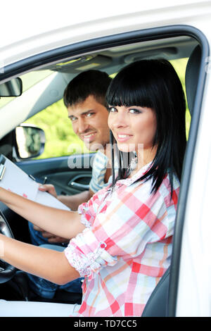 Beautiful young woman  taking driving lesson Stock Photo
