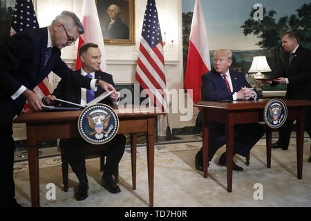 Washington, District of Columbia, USA. 12th June, 2019. US President DONALD J. TRUMP and Polish President ANDRZEJ DUDA participate in a signing ceremony in the Diplomatic Reception Room of the White House. President Trump and President Duda signed an agreement to increase military to military cooperation including the purchase of F-35 fighter jets by Poland and an increased US troop presence in Poland. Credit: Shawn Thew/CNP/ZUMA Wire/Alamy Live News Stock Photo