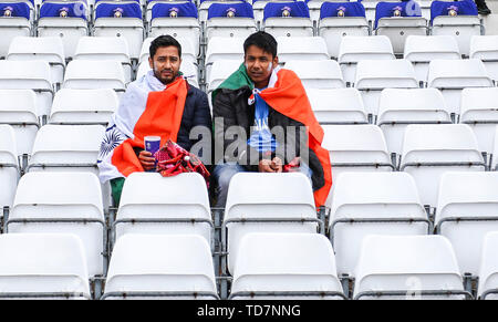 Trent Bridge, Nottingham, UK. 13th June, 2019. ICC World Cup Cricket, India versus New Zealand; Two Indian fans sat waiting for the rain to stop Credit: Action Plus Sports/Alamy Live News
