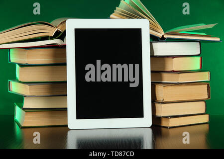Tablet and books on bright background Stock Photo