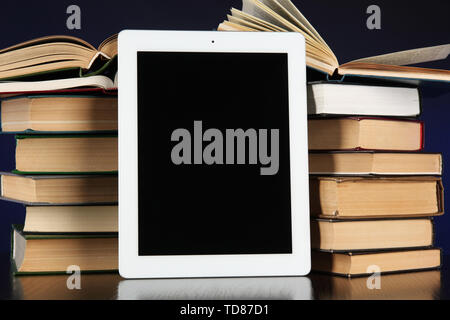 Tablet and books on bright background Stock Photo