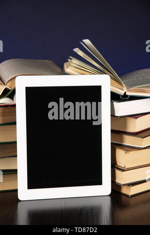 Tablet and books on bright background Stock Photo
