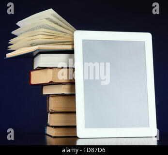 Tablet and books on bright background Stock Photo