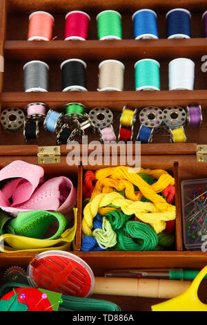 Sewing kit in wooden box close-up Stock Photo