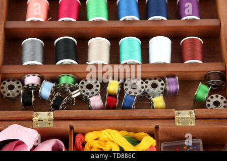 Sewing kit in wooden box close-up Stock Photo