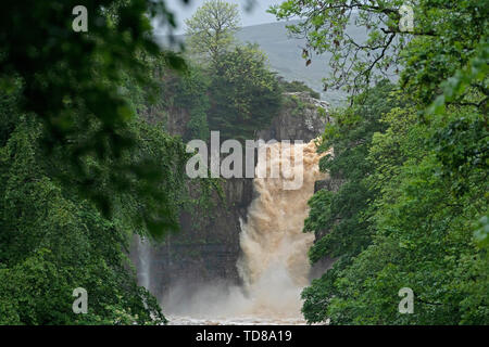 Water gushes over the High Force Waterfall on the River Tees in Teesdale, near Middleton-in-Teesdale in the Northern Pennines after days of heavy rainfall across the UK. Stock Photo