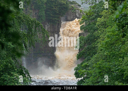 Water gushes over the High Force Waterfall on the River Tees in Teesdale, near Middleton-in-Teesdale in the Northern Pennines after days of heavy rainfall across the UK. Stock Photo