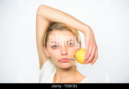 Lemon with hobnail natural battery. Recharge your body vitamins. Girl drink fresh juice whole lemon fruit. Healthy lifestyle and organic nutrition. Nutritious drink fill with energy. Battery concept. Stock Photo