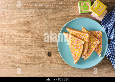 Traditional Australian fairy bread on wooden table Stock Photo