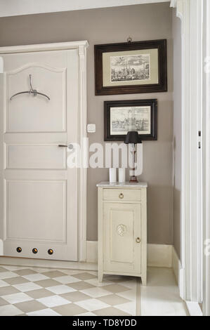 Cabinet with marble top next to bathroom entrance in hallway  UK & IRISH USE ONLY Stock Photo