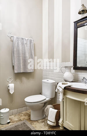 Soap on white towel and ceramic jug next to wash basin in stand in traditional bathroom   UK & IRISH USE ONLY Stock Photo