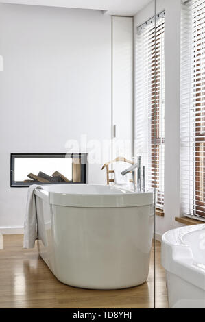 Reflection of freestanding bathtub in minimalist bathroom   UK & IRISH USE ONLY Stock Photo